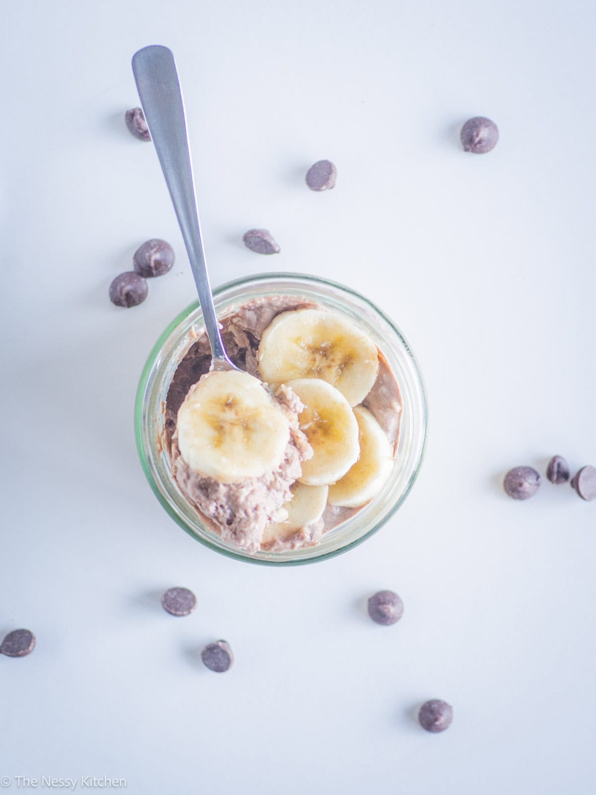 Spoon taking a scoop of overnight oats.