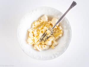 Banana mashed in a bowl.