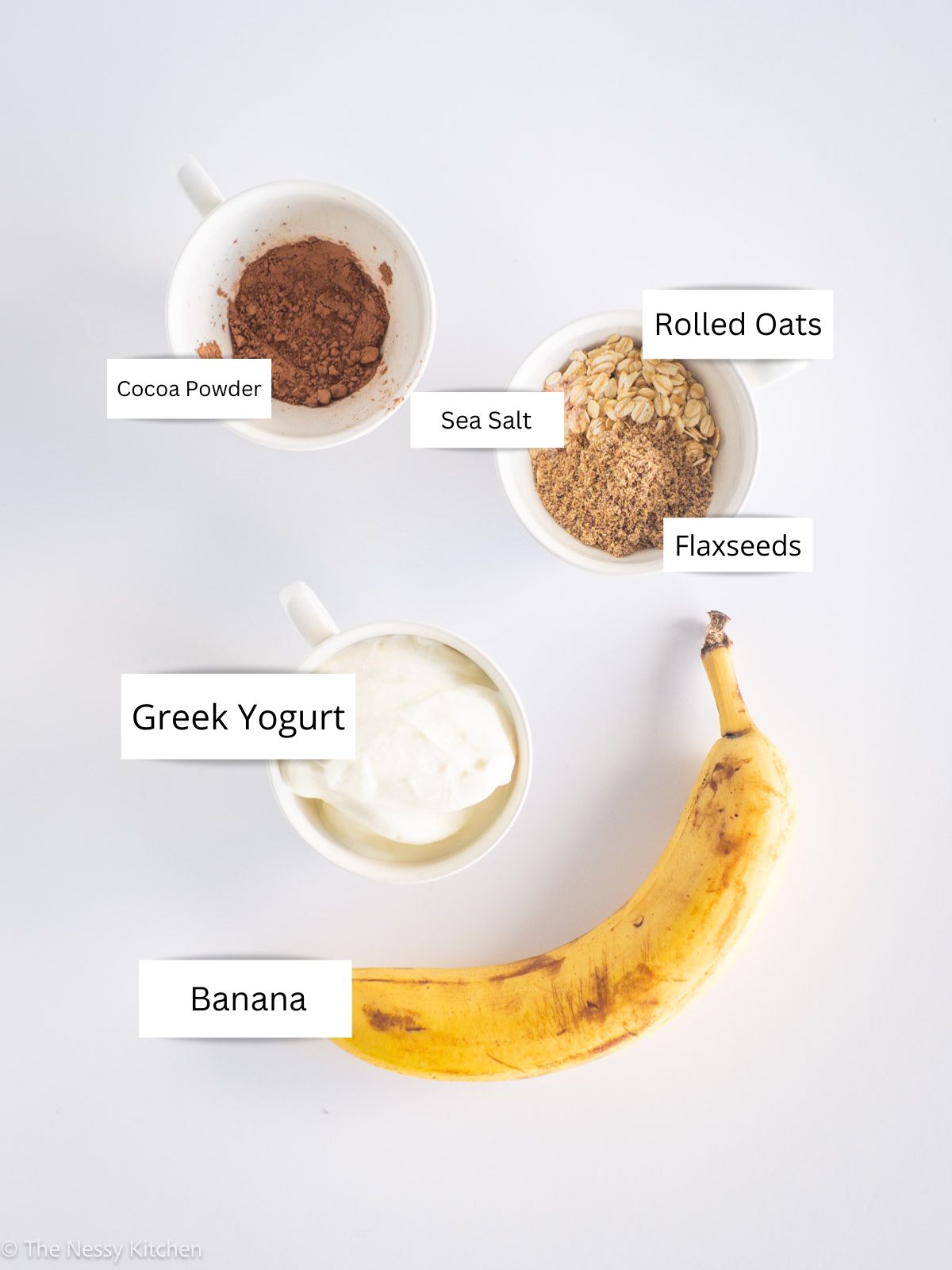 Oats, cocoa, banana and yogurt measured out.