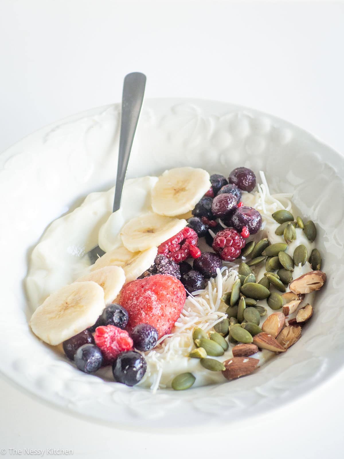 Greek yogurt in a bowl with toppings.