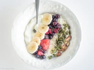 Yogurt topped with fruit and nuts.