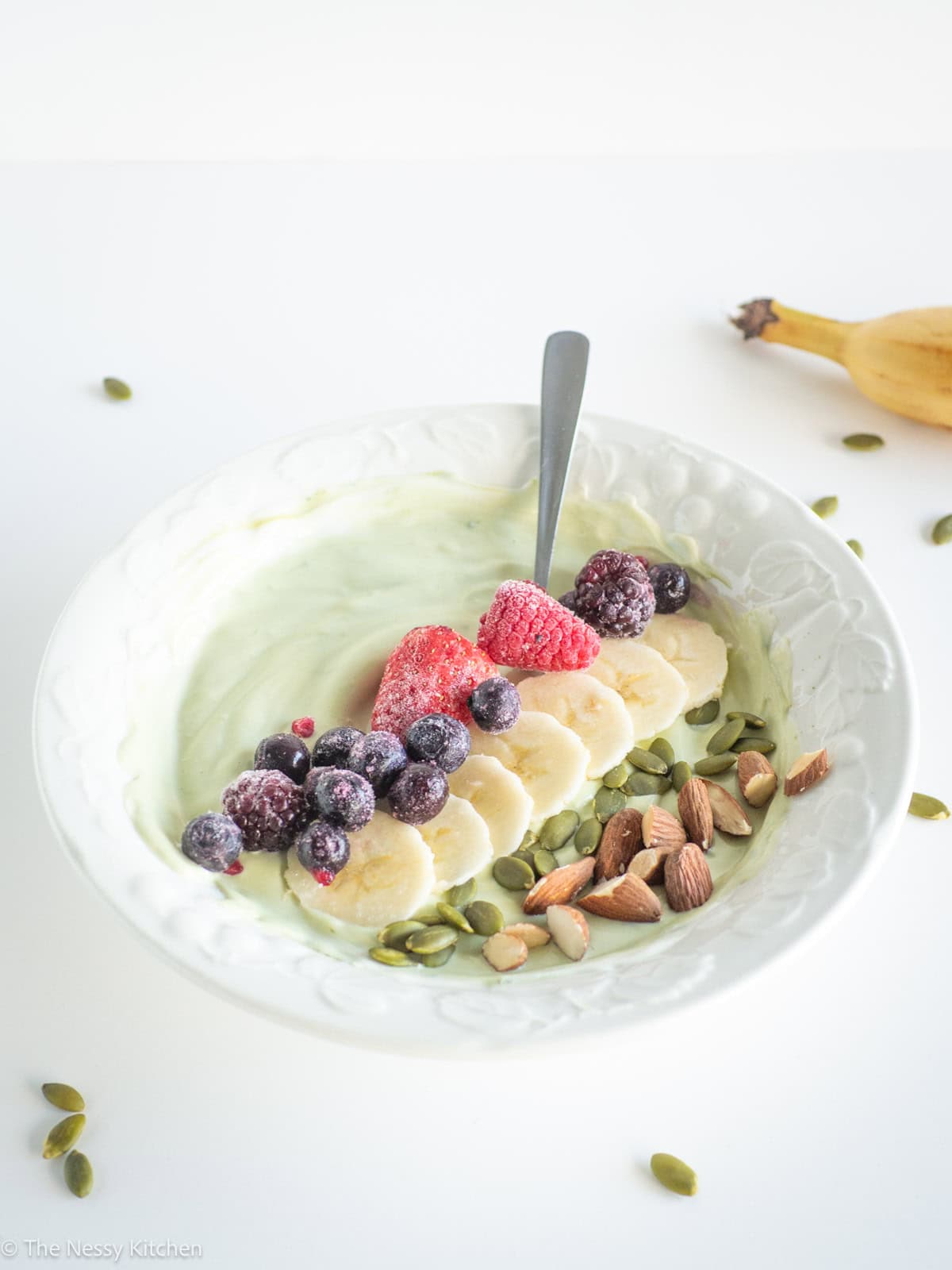 Matcha yogurt in a bowl with fruit.
