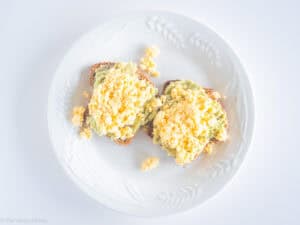 Scrambled eggs spread on toast.
