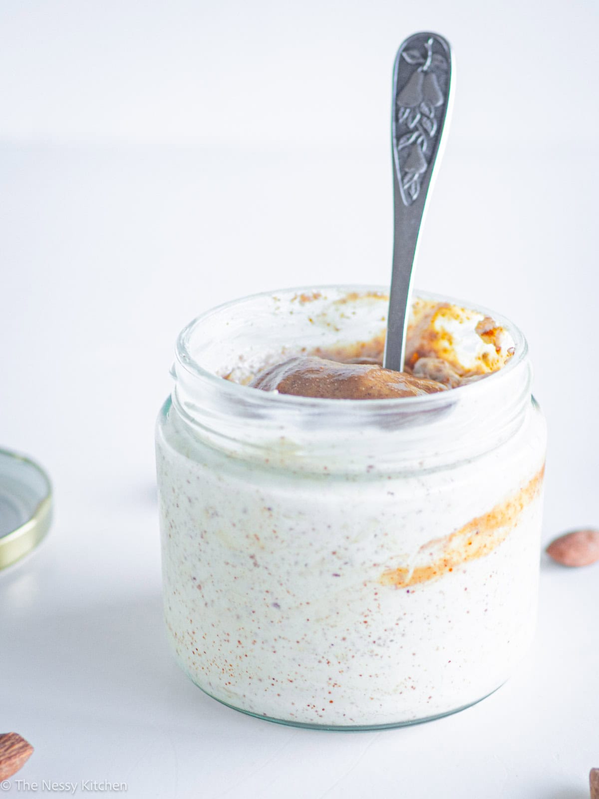 Jar of overnight oats with a spoon.
