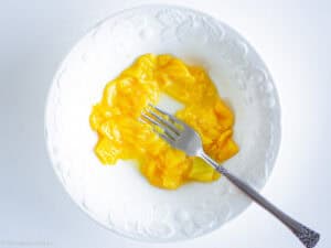 Mashed mango in a bowl.