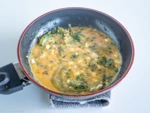 Egg mixture poured over vegetables.
