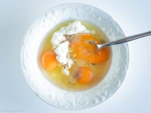 Eggs whisked together with cottage cheese.