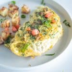 Omelet and potatoes on a plate.