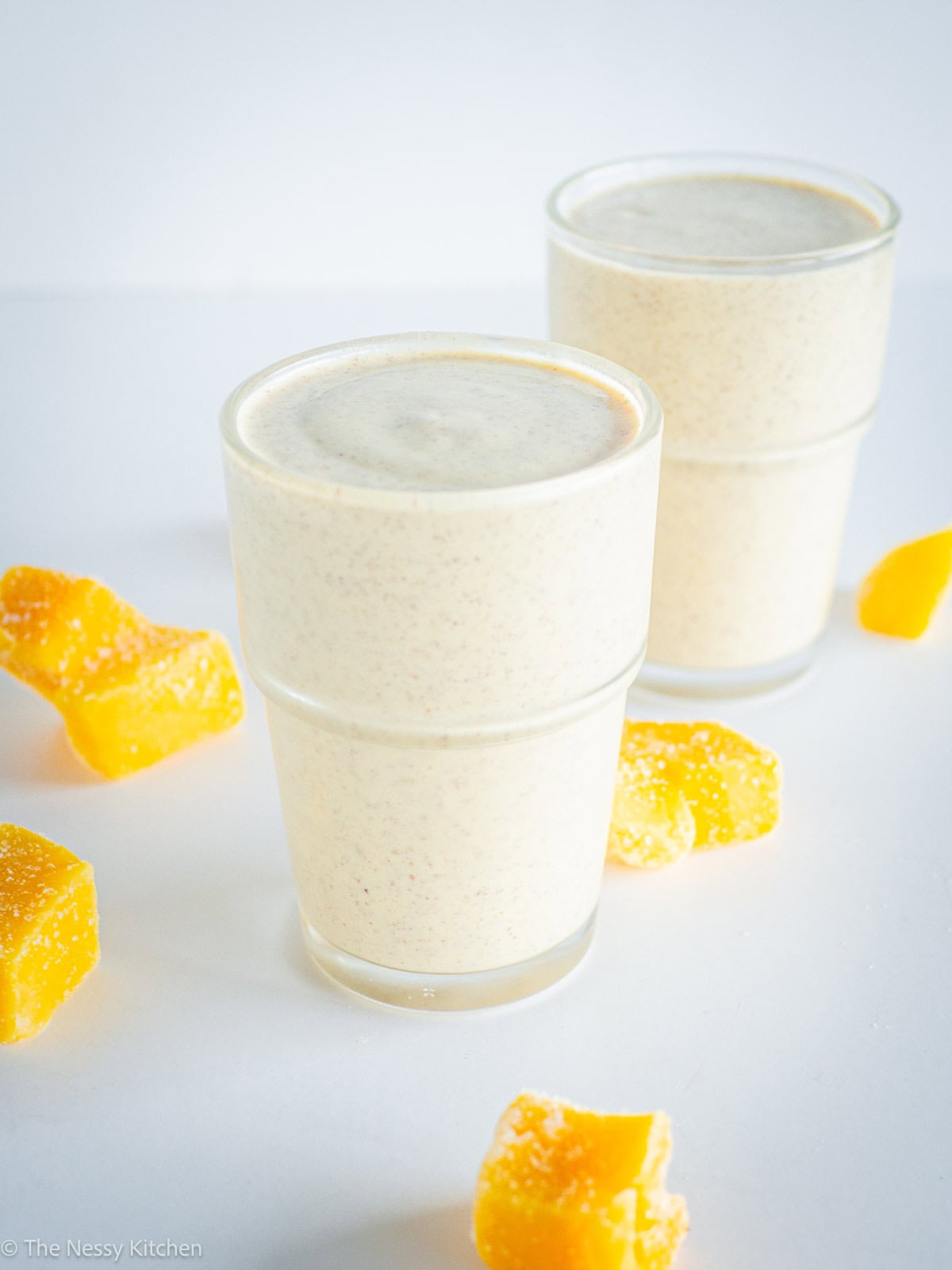 Mango smoothie divided into two glasses.