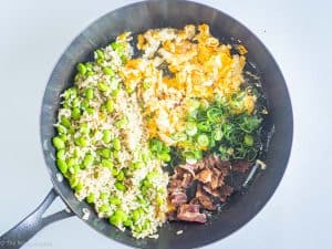 Green onions and bacon added in pan.