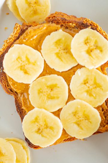 Almond butter banana toast on plate.