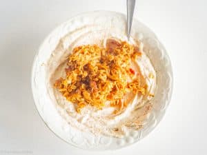 Apple topping added to yogurt bowl.