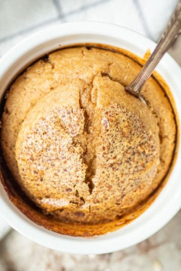 Baked oats in a ramekin with a spoon.