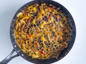 Whisked eggs into pan with beans, ground beef, bell pepper, and onions.