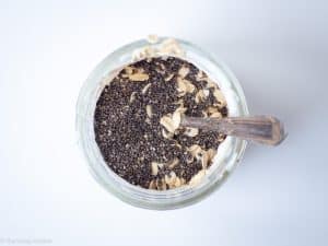 Oats and chia added to a jar of yogurt.
