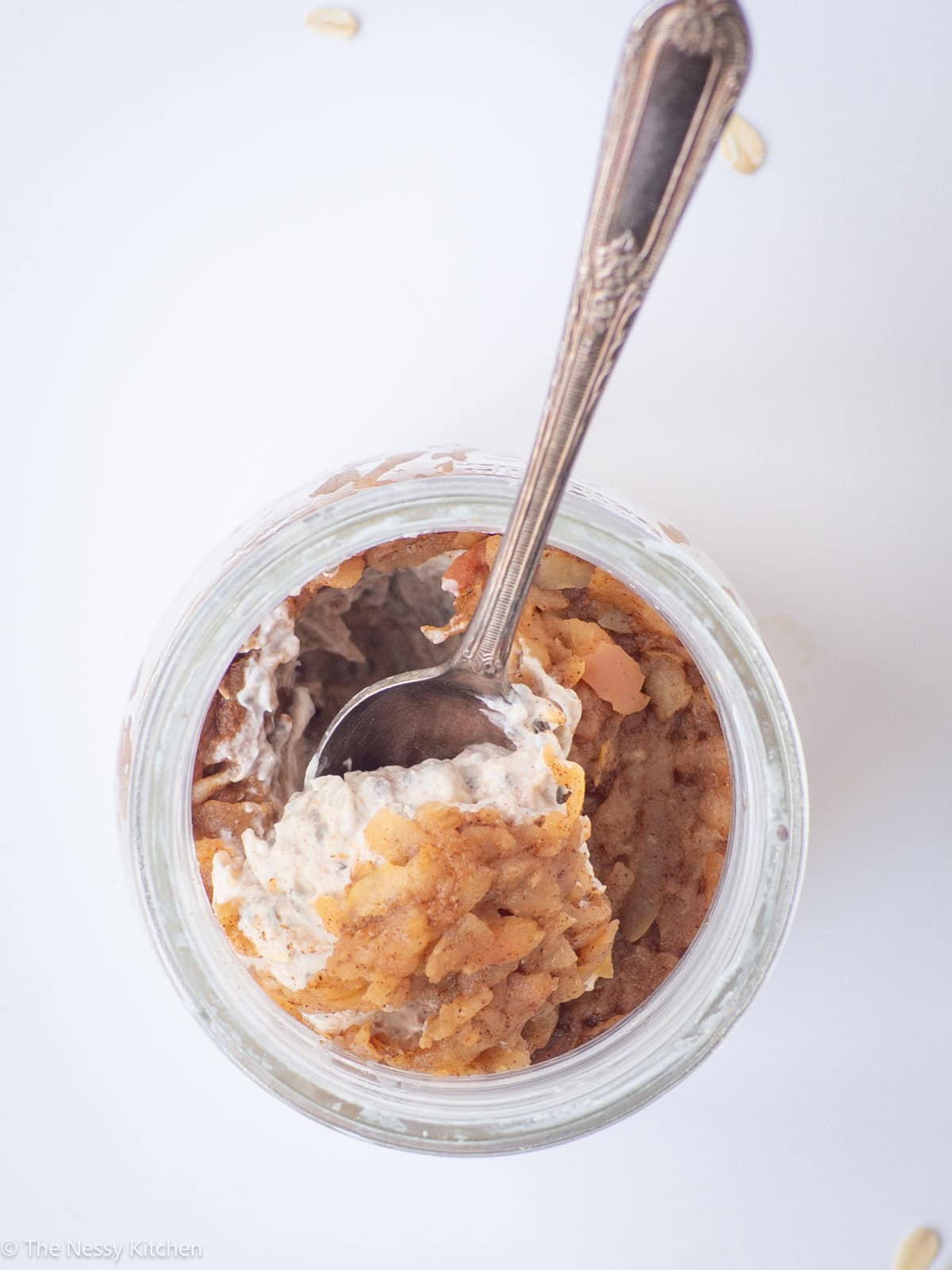 Jar of overnight oats topped with apple.
