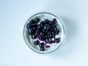 Blueberries added to top of glass jar.
