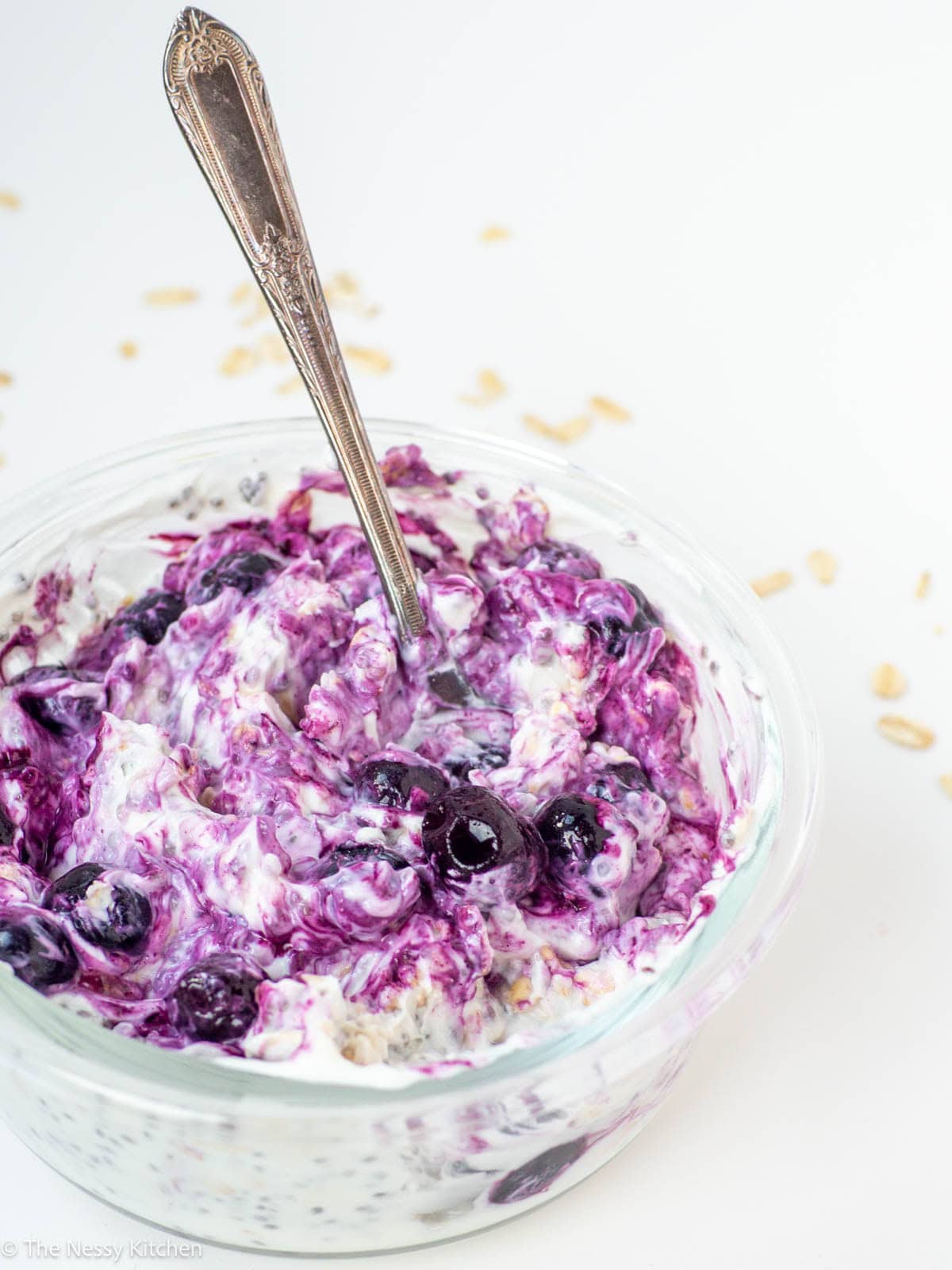 Blueberry overnight oats with spoon on counter.