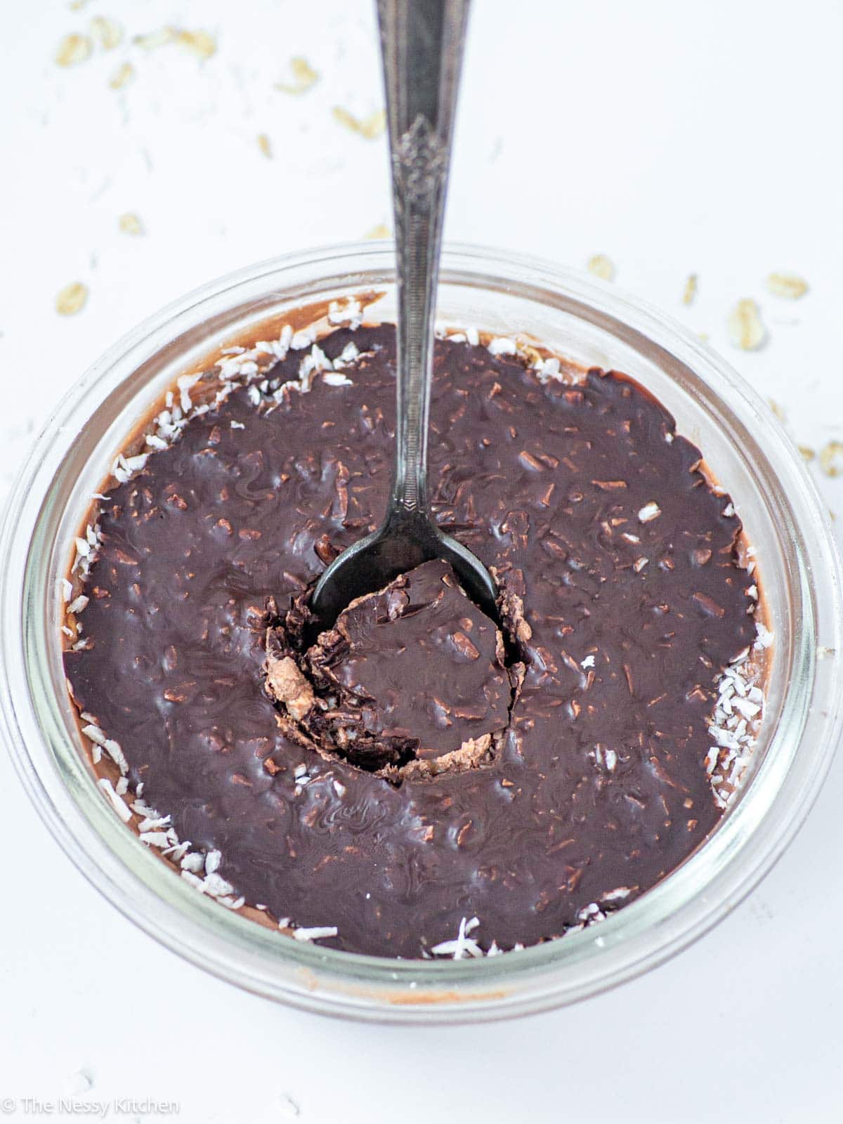 Spoon scooping into a bowl of oatmeal.