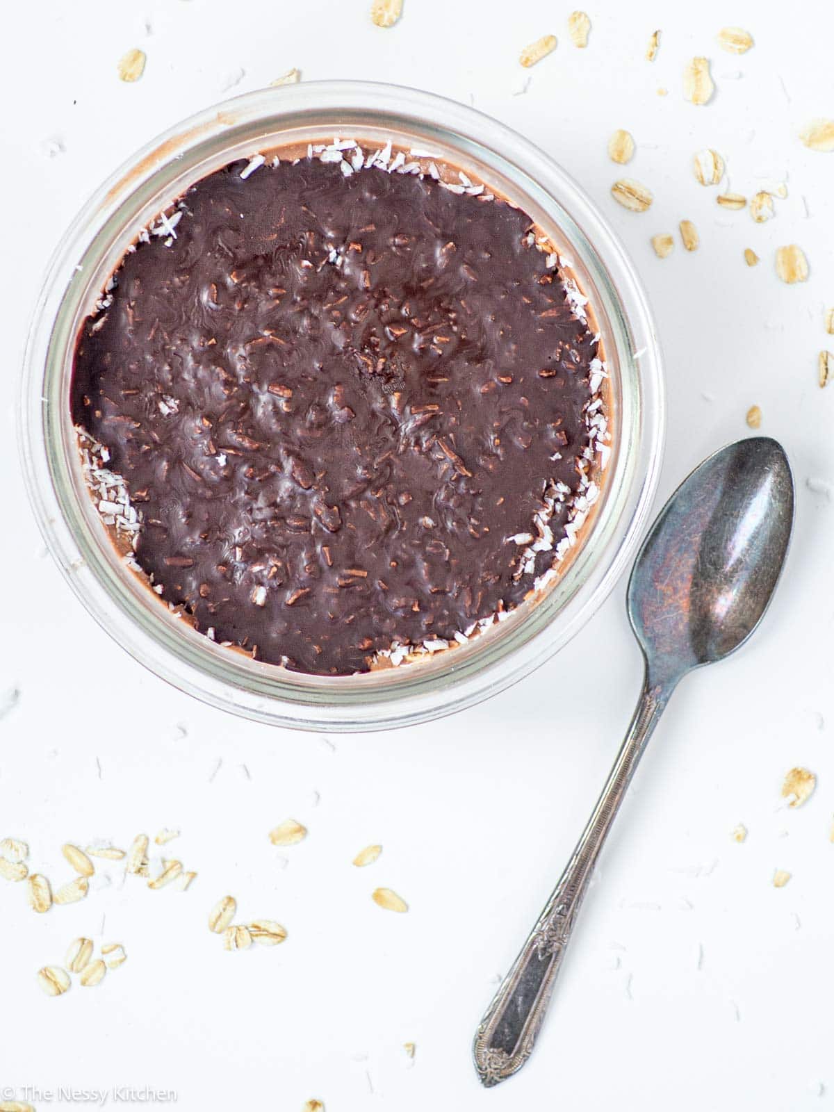 Bowl of chocolate coconut overnight oats with a spoon.