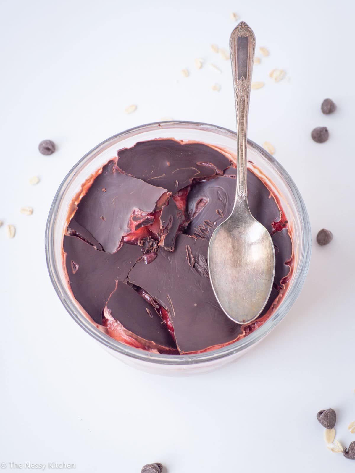 Chocolate covered strawberry overnight oats in a bowl with a spoon.
