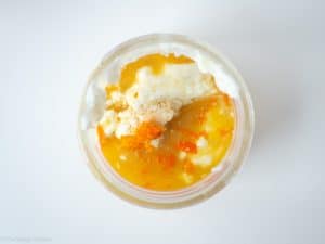 Orange juice and Greek yogurt in a jar.