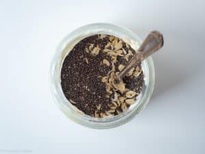 Chia seeds and oats added to a jar.
