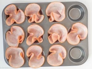 Ham slices in a muffin tin.