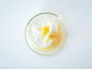 Lemon, honey and yogurt in a bowl.