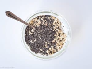 Oats and chia added to a container.