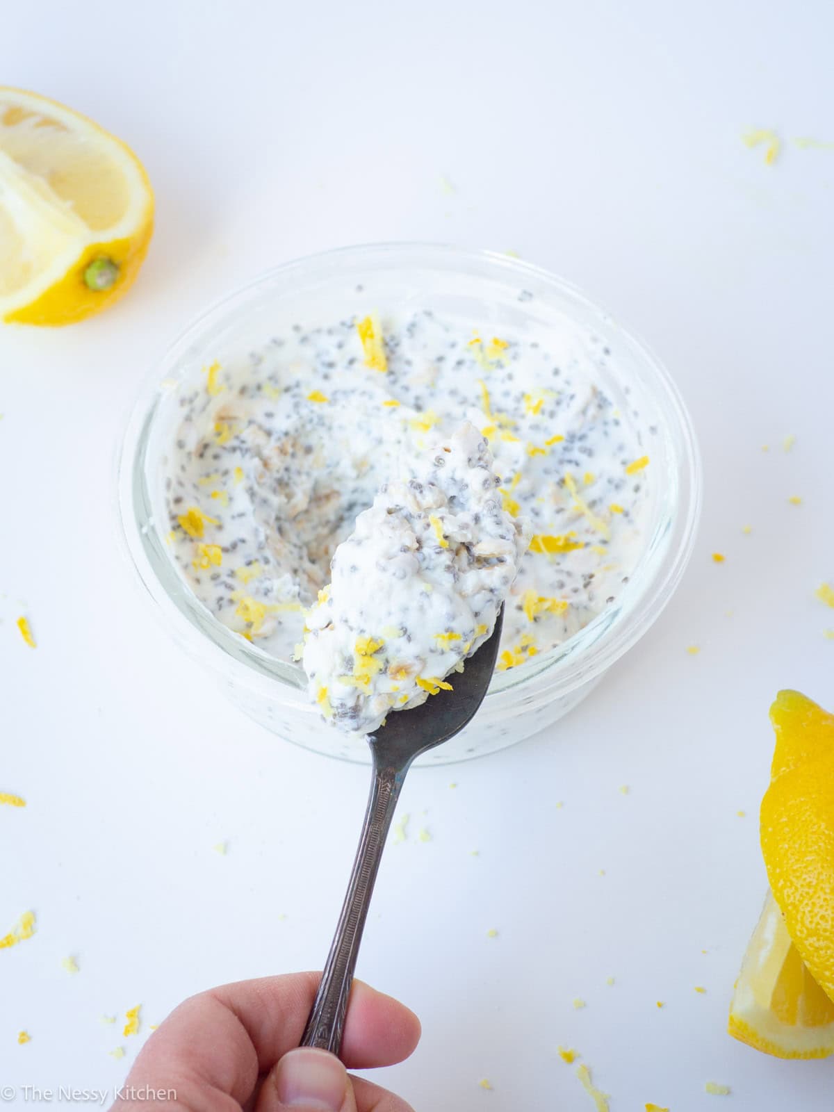 Spoon taking a scoop from a bowl of overnight oats.