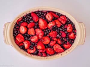 Berries and chia mixed in a baking dish.