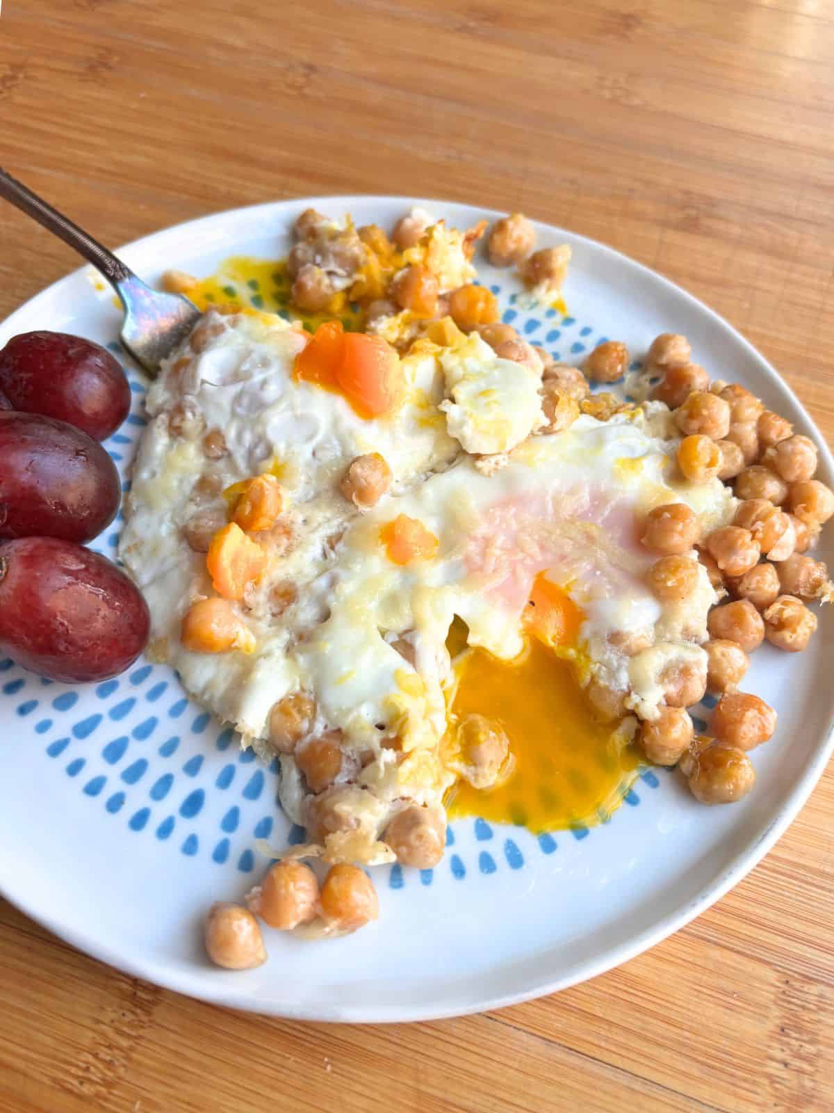 Parmesan chickpea fried eggs on a plate.
