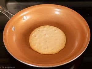 Pancake cooking in a pan.