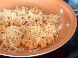 Parmesan and chickpeas in a pan.