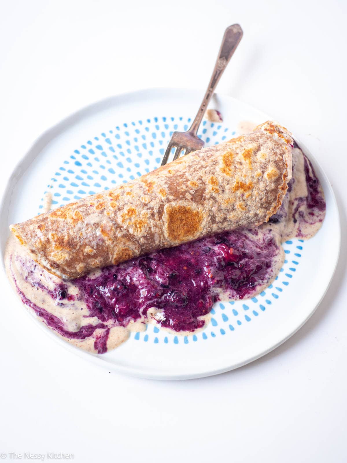 French toast wrap on a plate filled with jam.