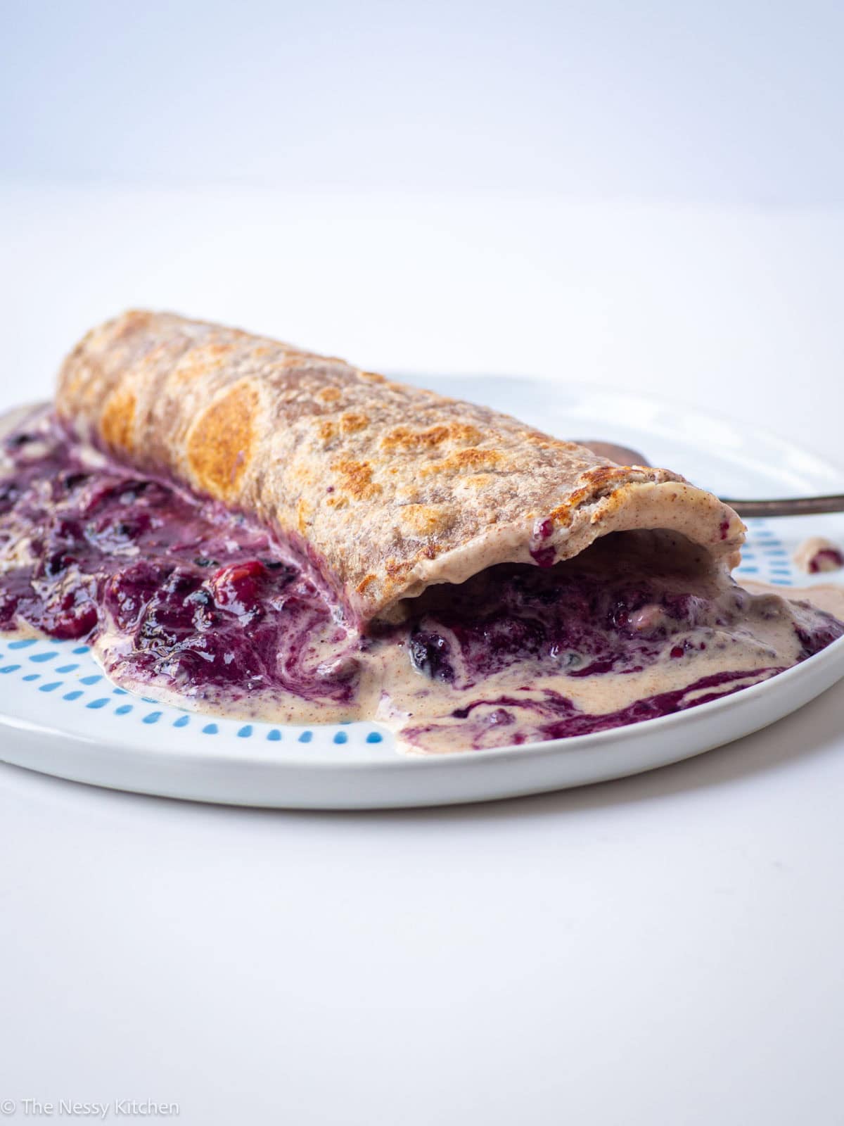 French toast wrap on a plate with a fork.