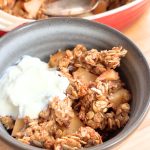 Bowl of breakfast crisp topped with yogurt.