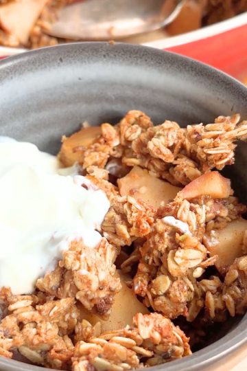 Bowl of breakfast crisp topped with yogurt.