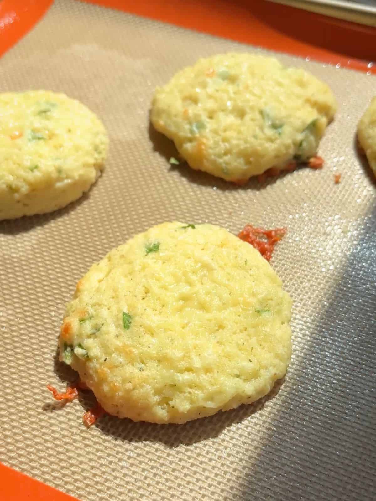Cheddar herb breakfast biscuits on a sheet pan.