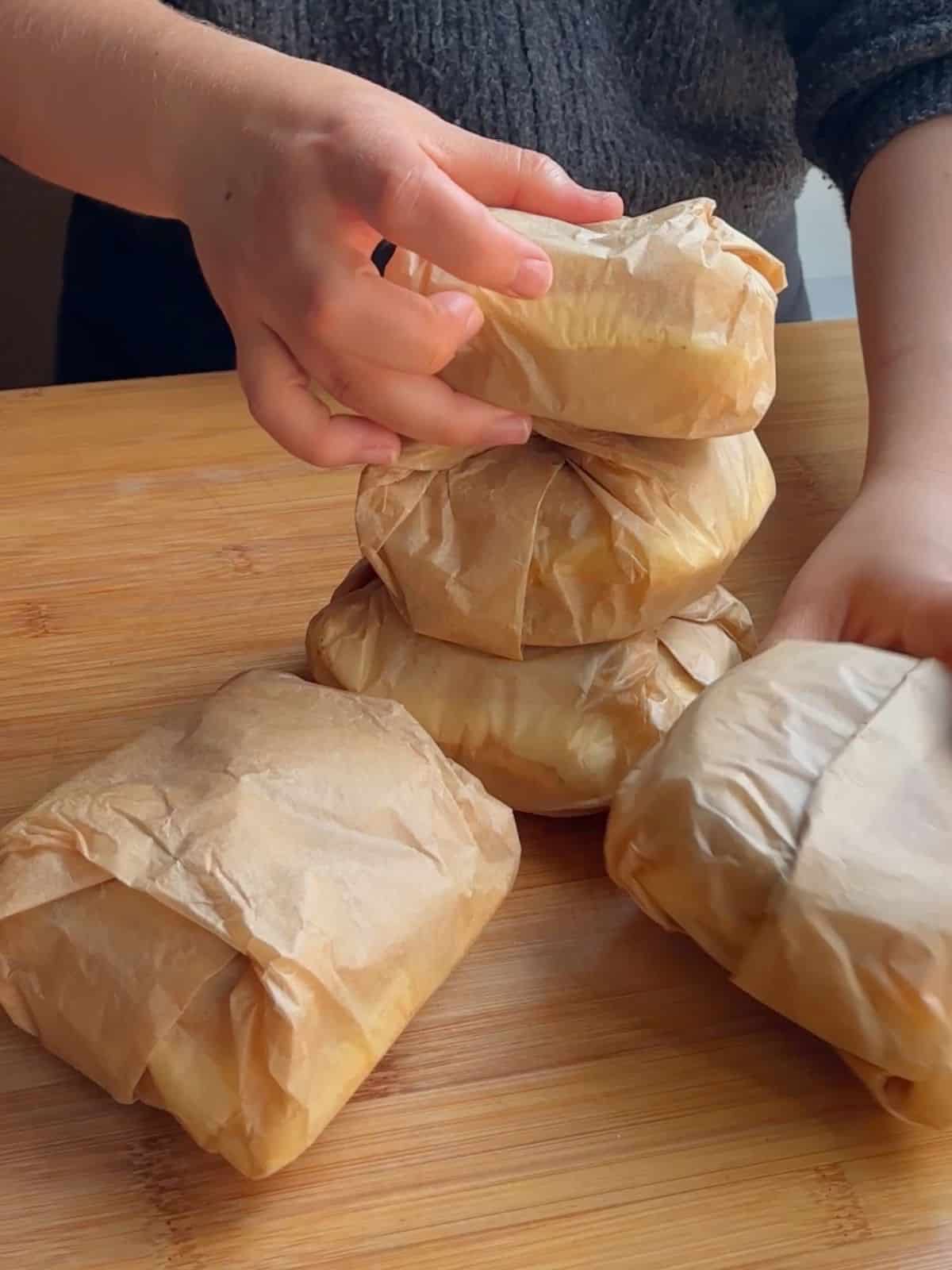 Breakfast sandwiches wrapped in paper.