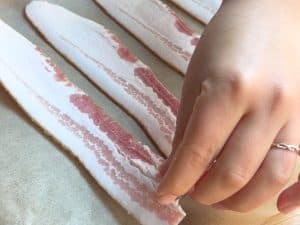 Bacon placed on a baking sheet.