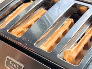 Waffles placed in a toaster.