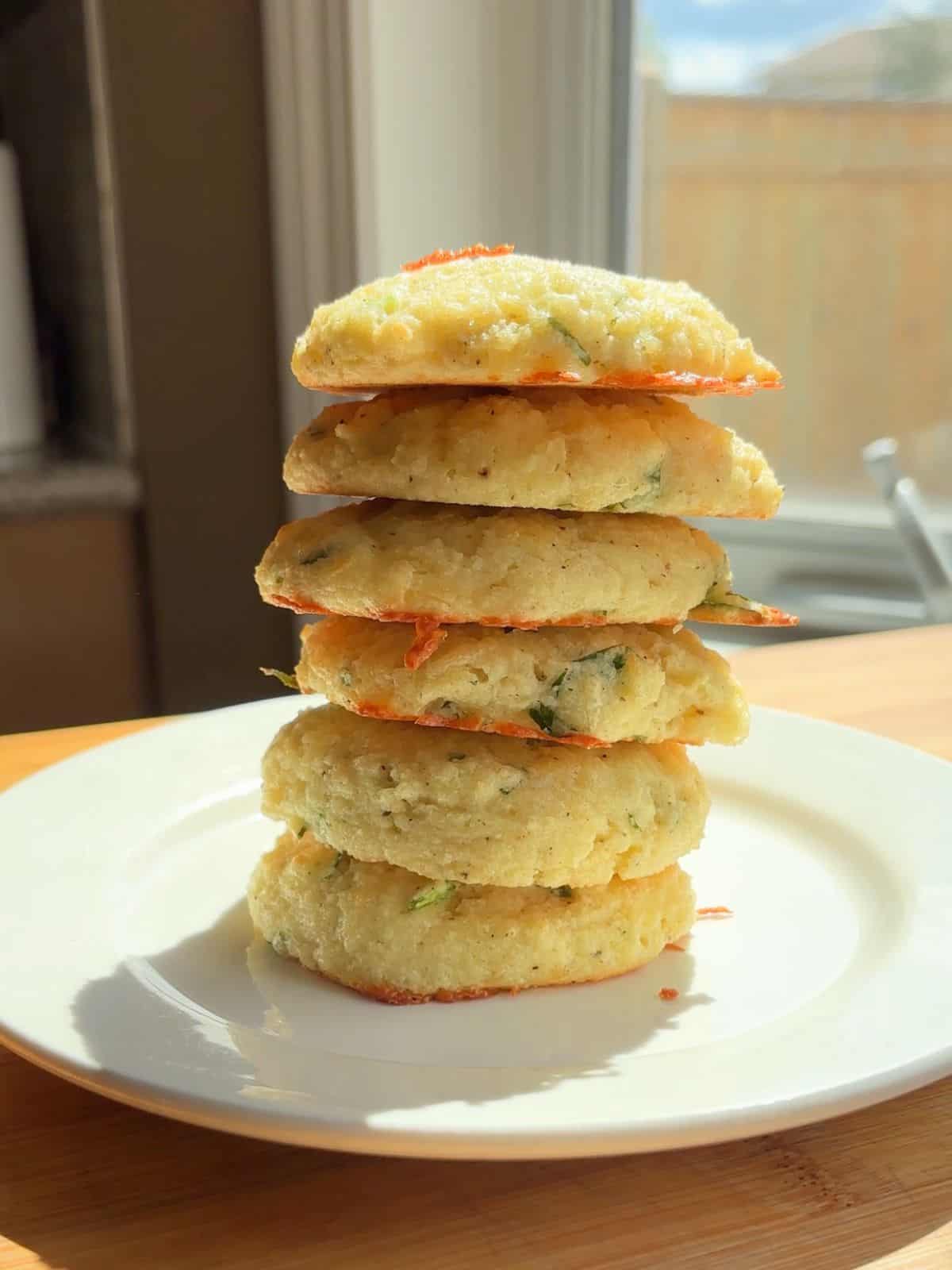 Stack of high protein breakfast biscuits on a plate.