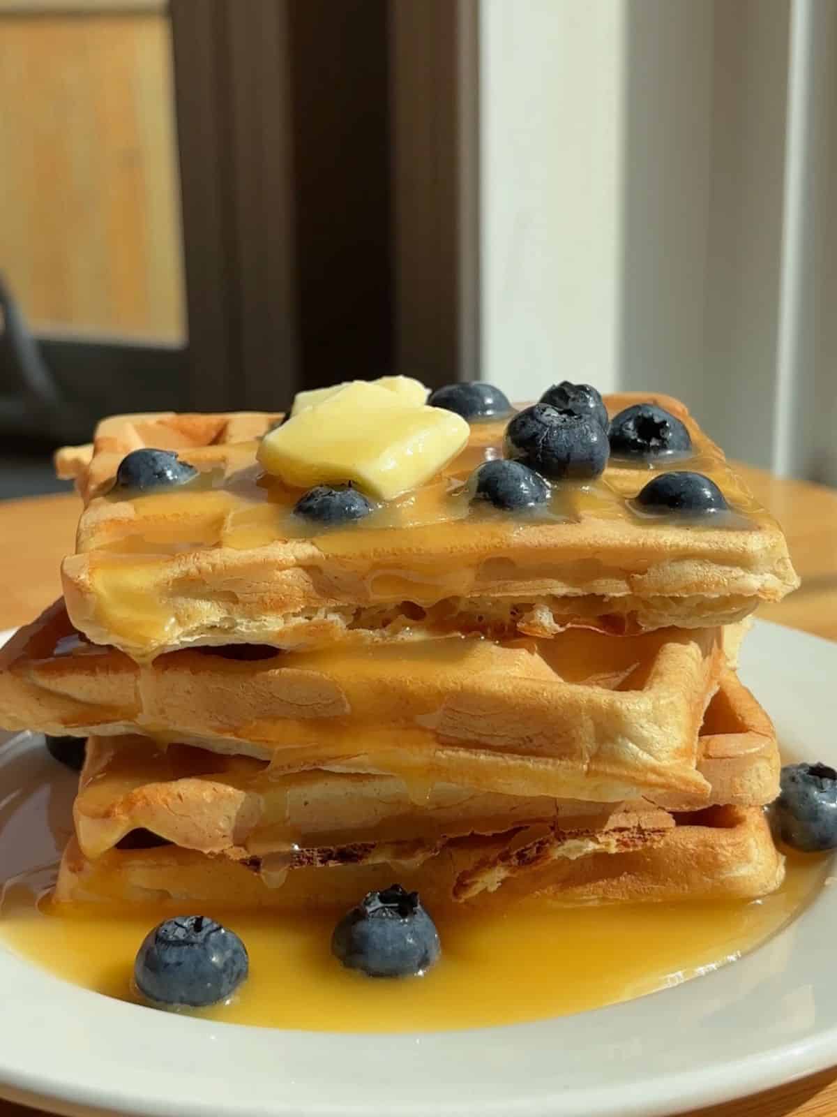 Waffles stacked on a plate.