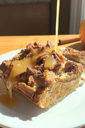 Syrup being poured over a slice of French toast casserole.