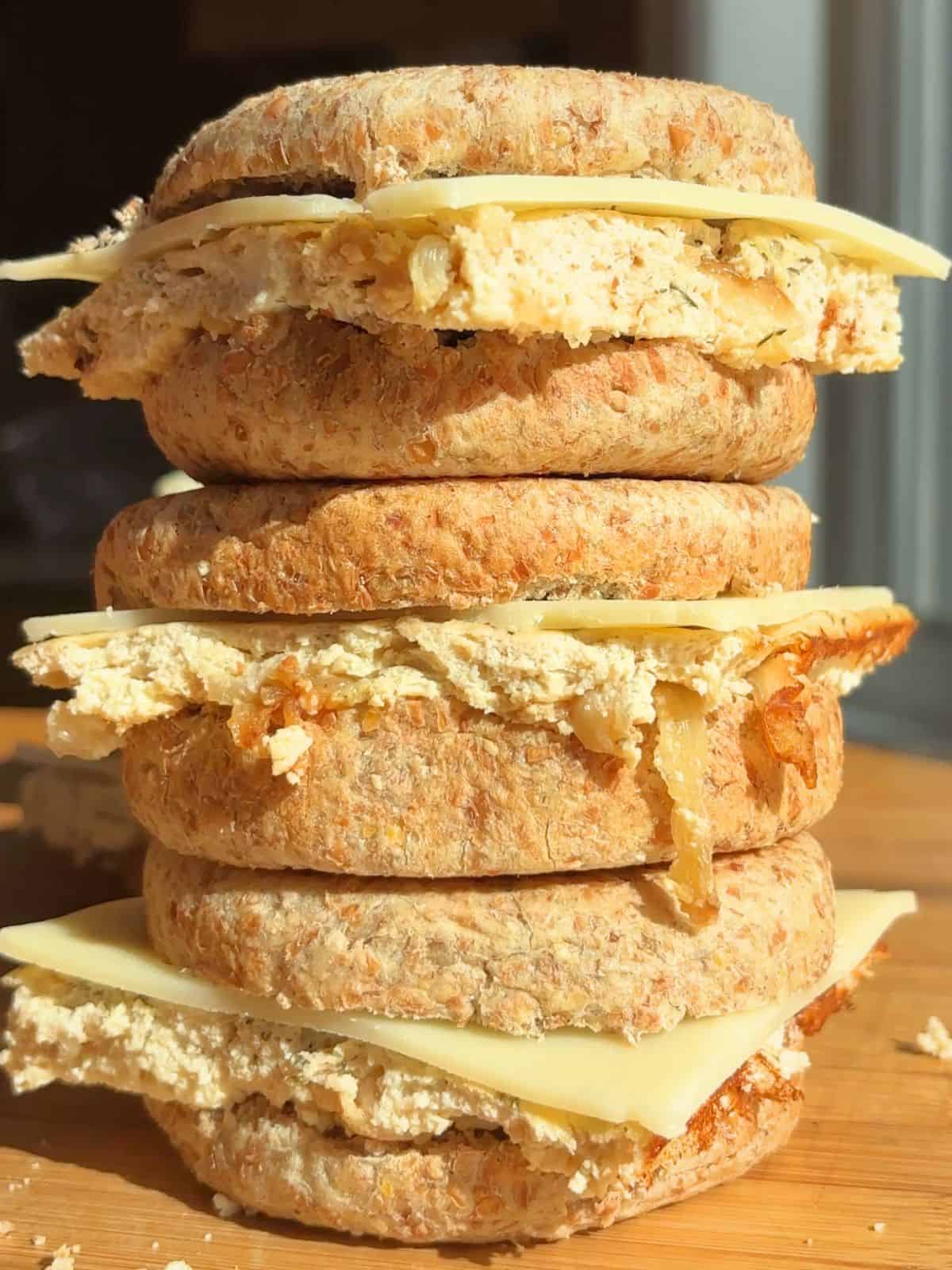 Stack of French onion breakfast sandwiches on a counter.